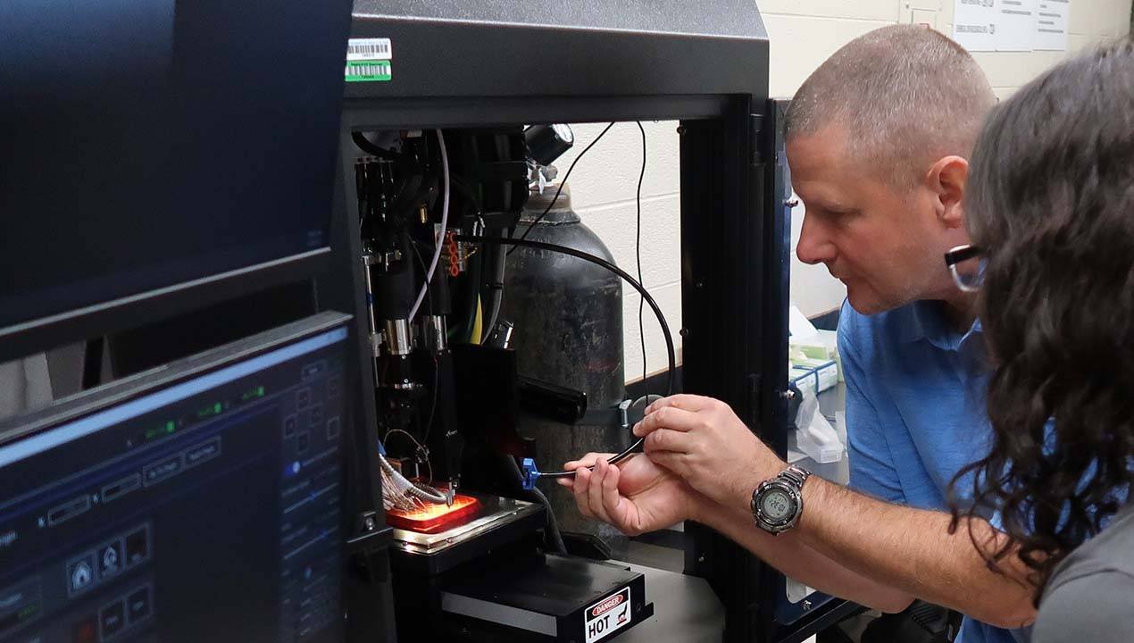 Raymond Rumpf working on a 3D printer