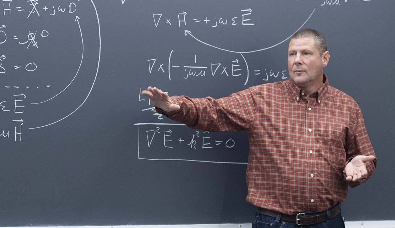 Raymond Rumpf teaching at a chalkboard